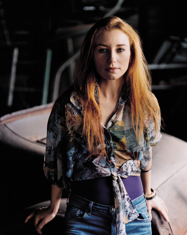 woman with red hair in patterned shirt