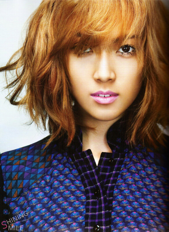 woman with red hair in patterned shirt
