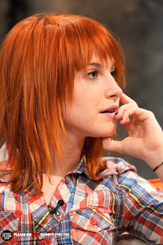 woman with red hair in plaid shirt