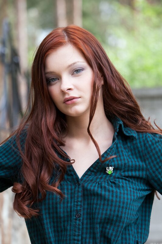 woman with red hair in plaid shirt