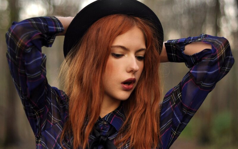 woman with red hair in plaid shirt