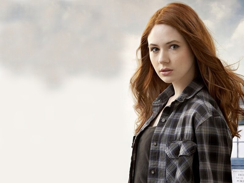 woman with red hair in plaid shirt