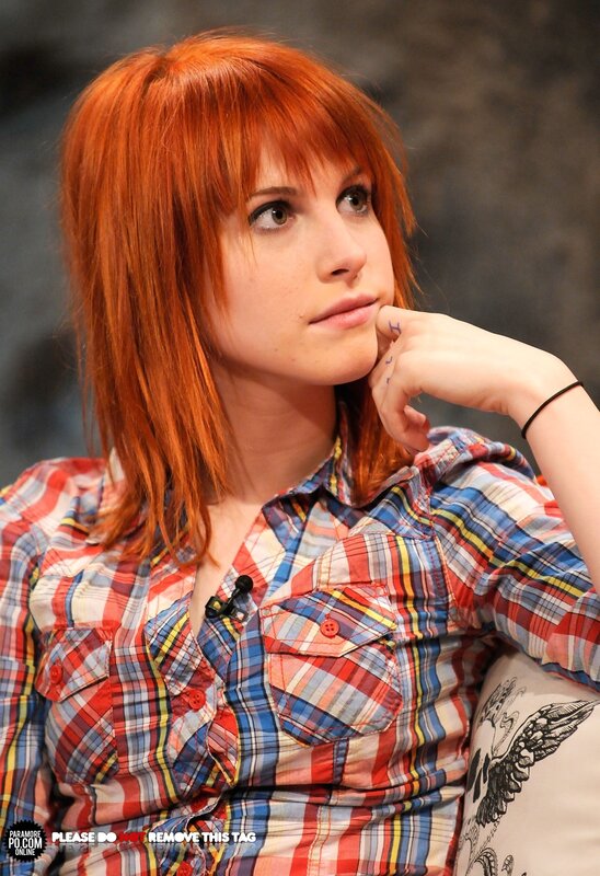 woman with red hair in plaid shirt