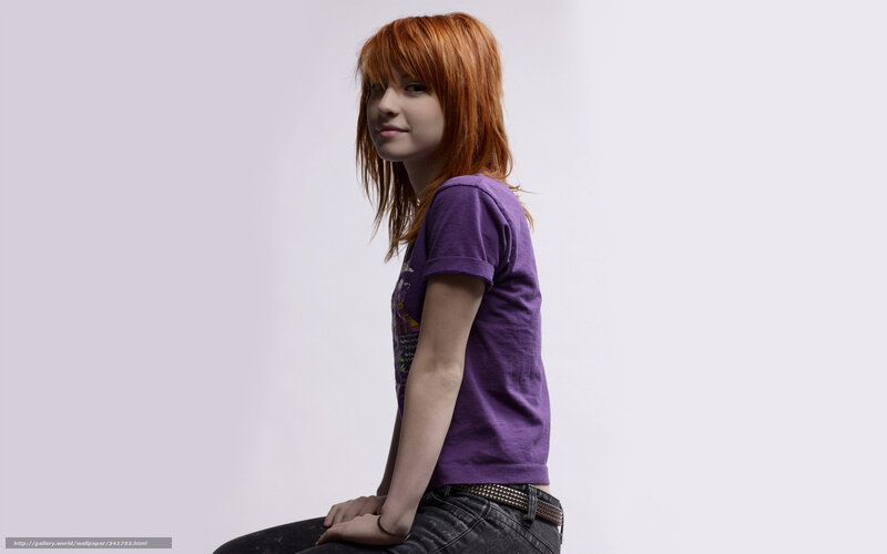 woman with red hair in purple shirt