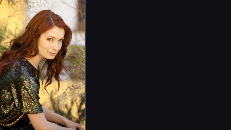 woman with red hair in sequin top