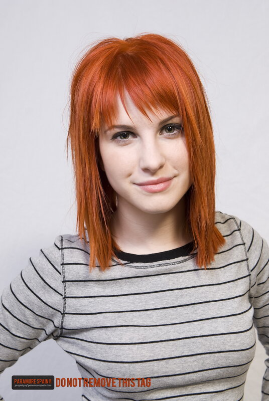 woman with red hair in striped shirt