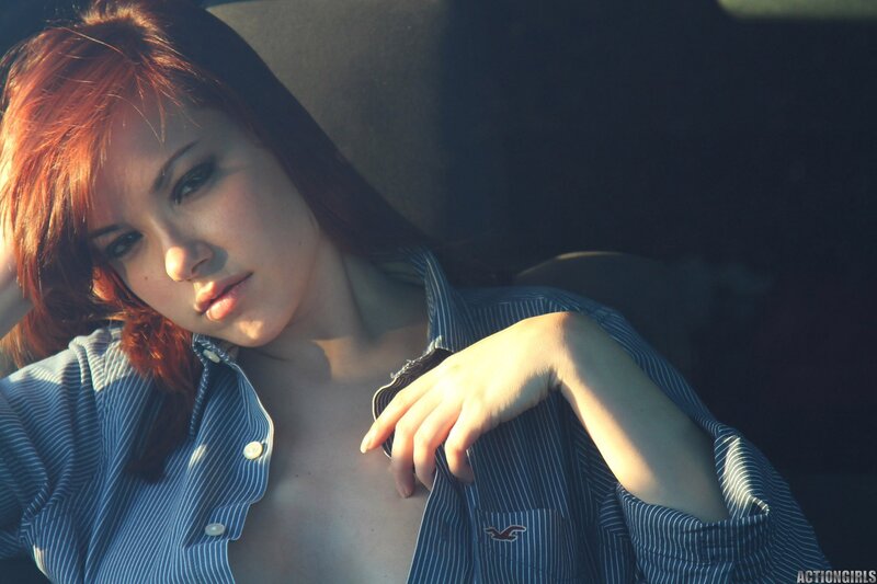 woman with red hair in striped shirt