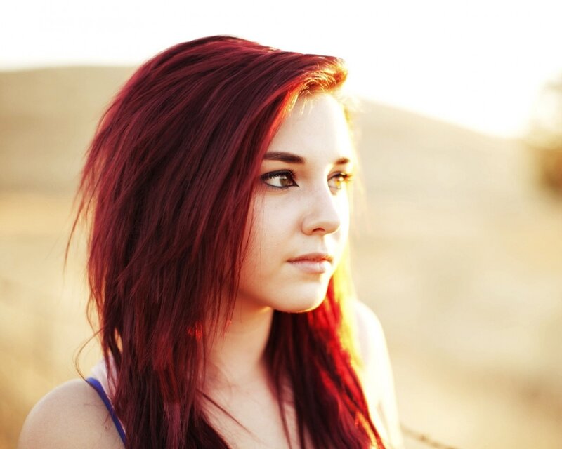 woman with red hair in sunset