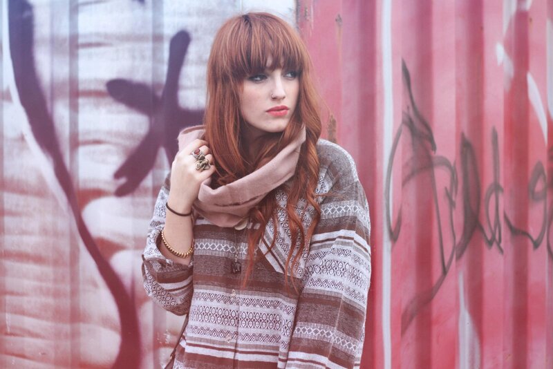 woman with red hair in urban setting