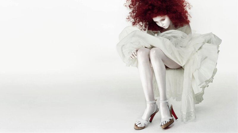 woman with red hair in white dress