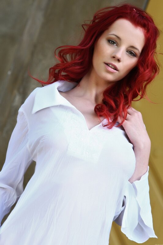 woman with red hair in white shirt