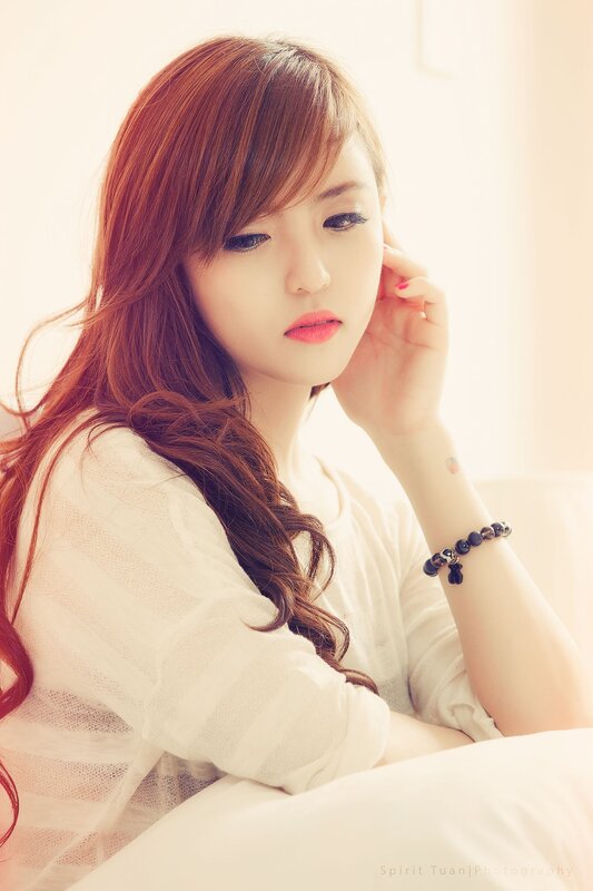 woman with red hair in white shirt
