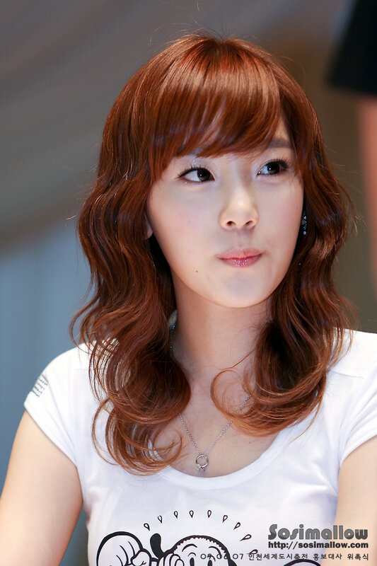 woman with red hair in white t-shirt