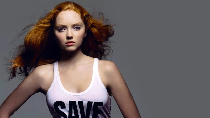woman with red hair in white tank top