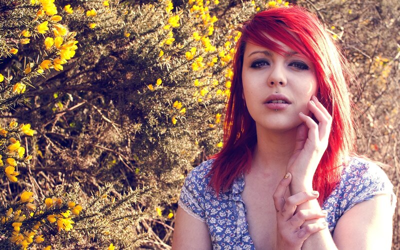 woman with red hair in yellow flowers
