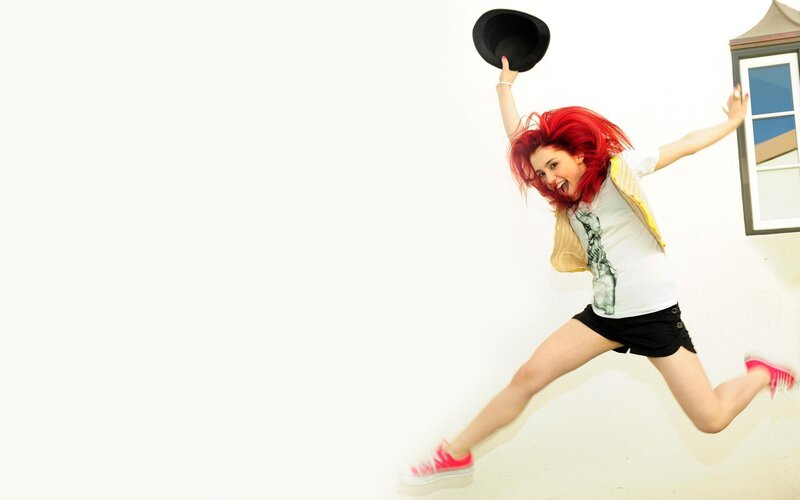 woman with red hair jumping