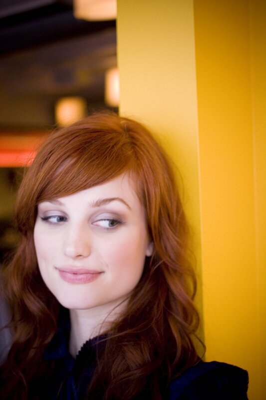 woman with red hair leaning