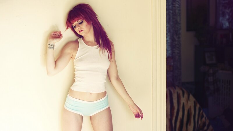 woman with red hair leaning