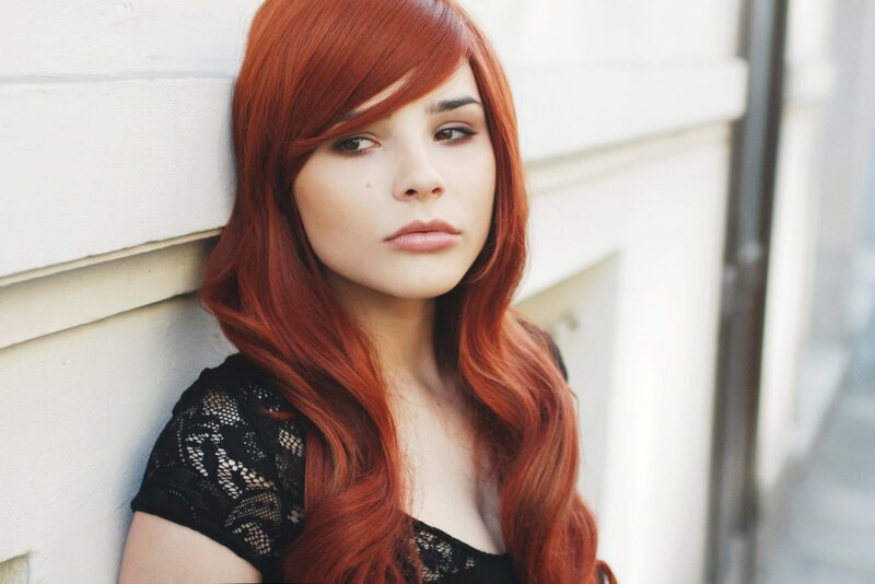 woman with red hair leaning