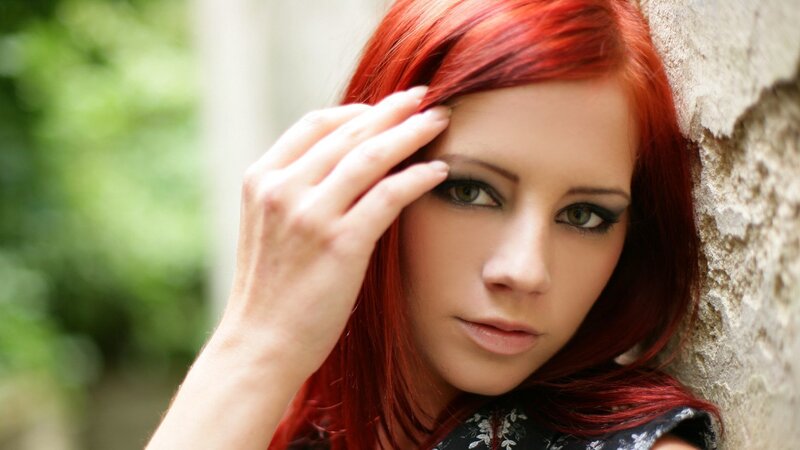 woman with red hair leaning