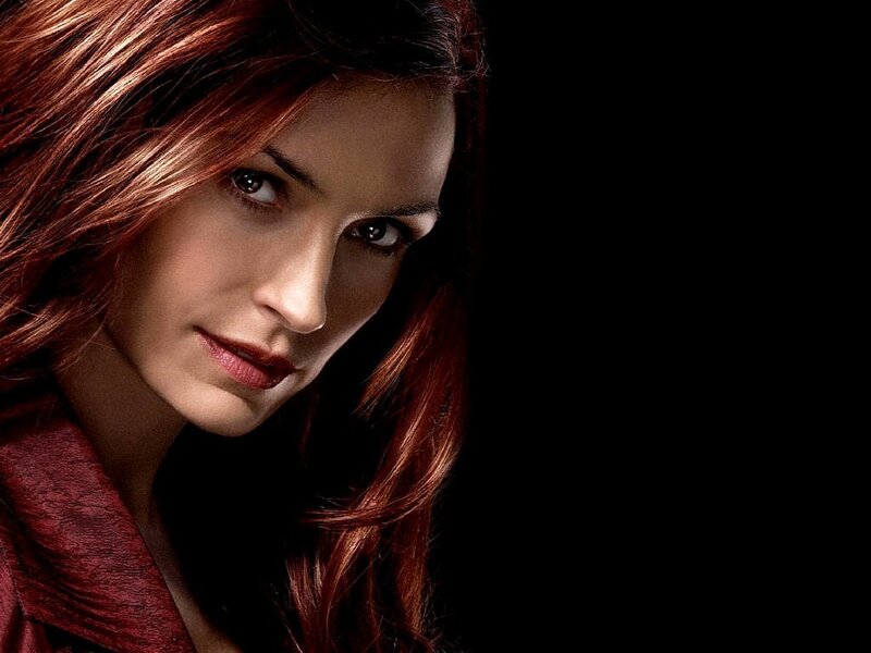 woman with red hair looking at camera