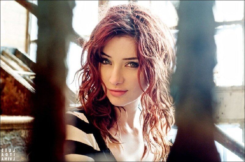 woman with red hair looking at camera