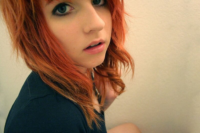 woman with red hair looking at camera