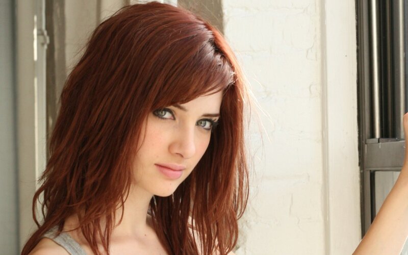 woman with red hair looking at camera