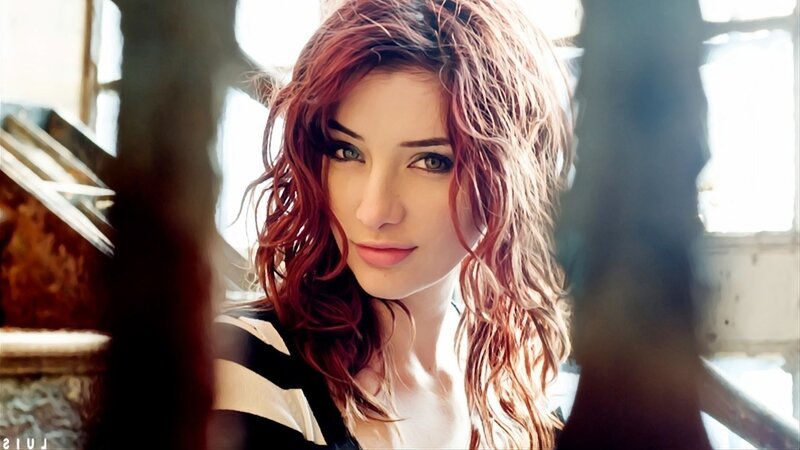 woman with red hair looking at camera