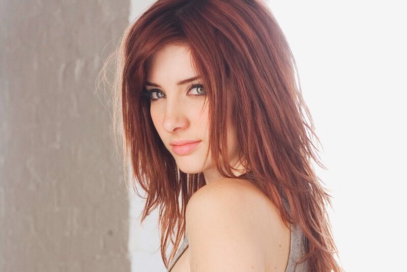 woman with red hair looking at camera