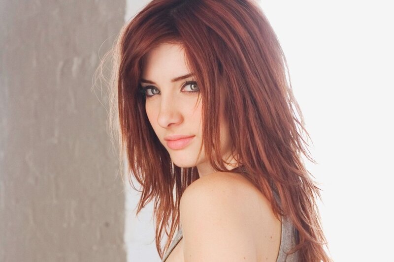 woman with red hair looking at camera