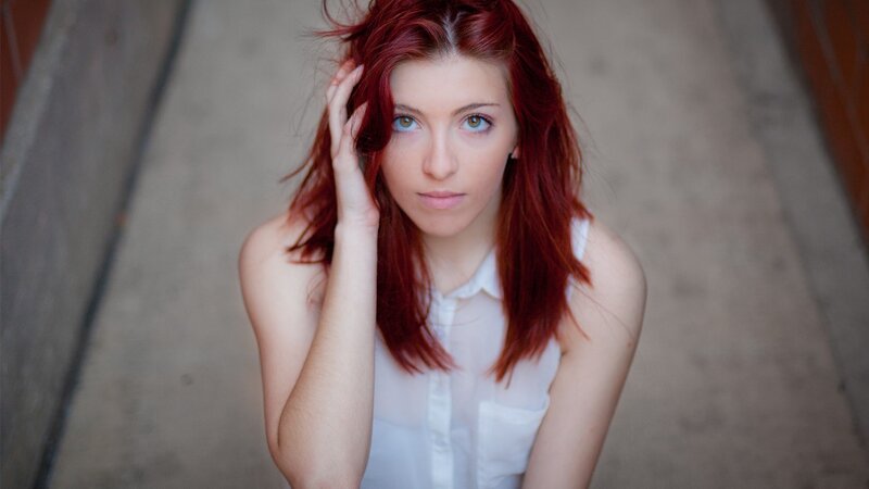 woman with red hair looking at camera