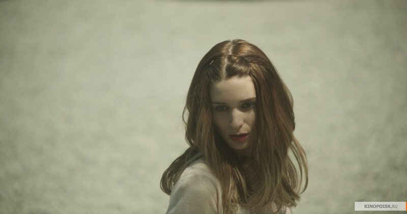 woman with red hair looking at camera