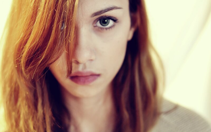 woman with red hair looking at camera