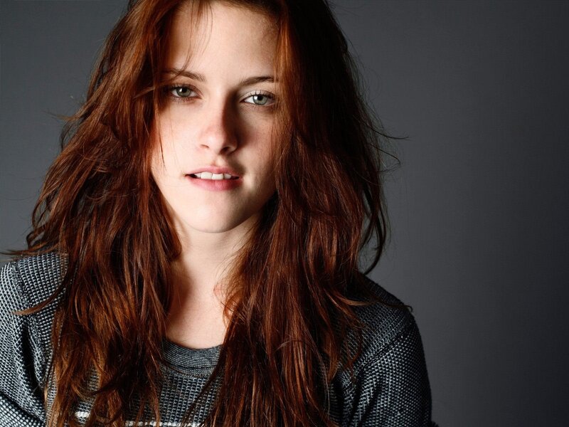 woman with red hair looking at camera