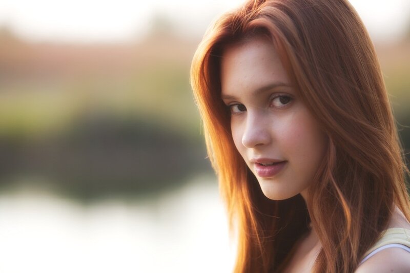 woman with red hair looking at camera