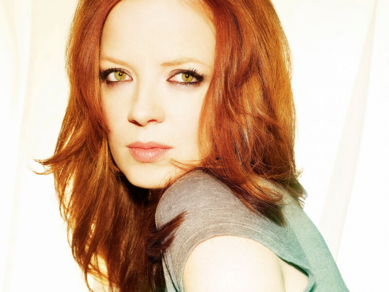 woman with red hair looking at camera