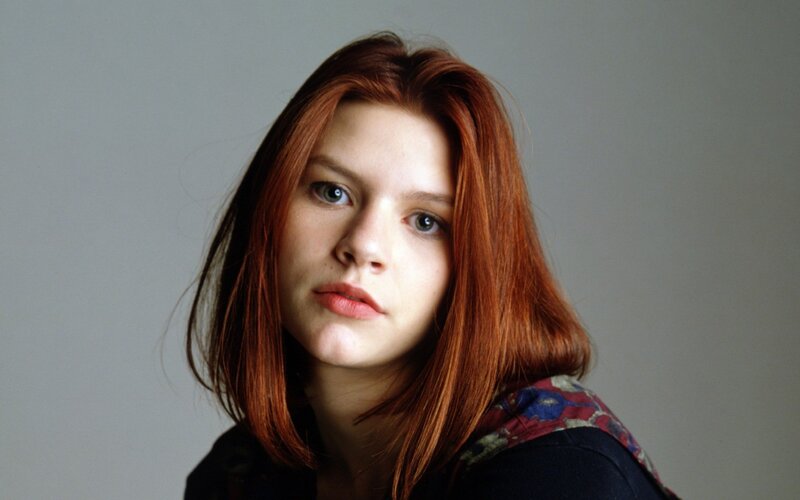 woman with red hair looking at camera