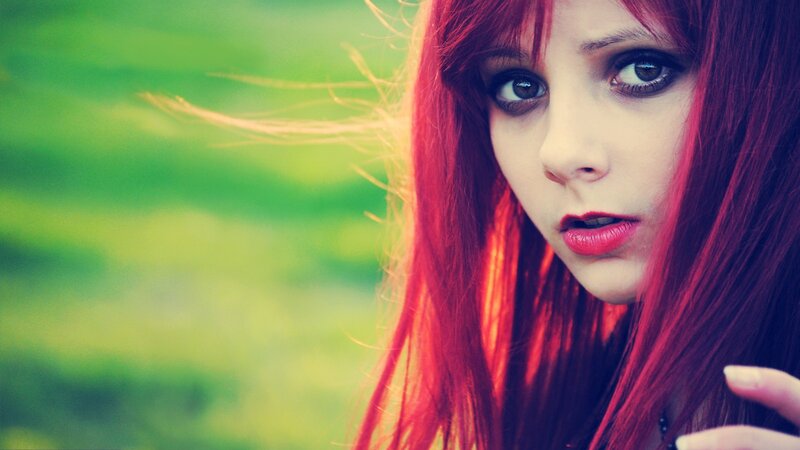 woman with red hair looking at camera