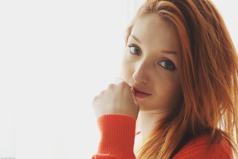 woman with red hair looking at camera