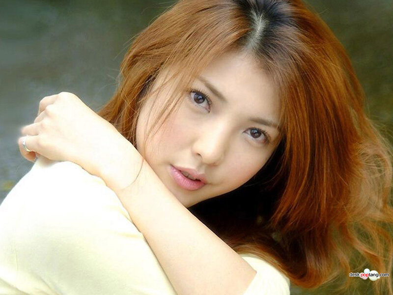 woman with red hair looking at camera