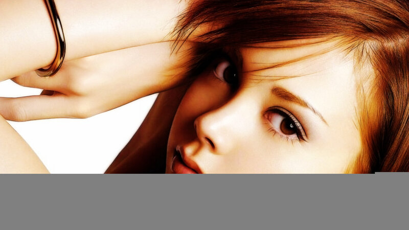 woman with red hair looking at camera