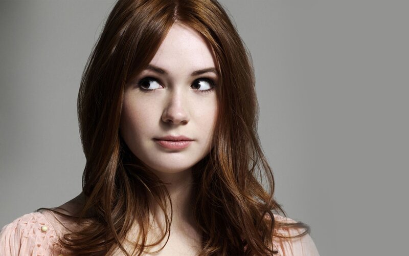 woman with red hair looking away