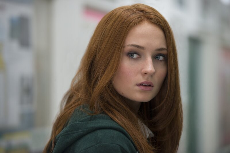 woman with red hair looking back