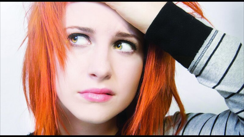 woman with red hair looking concerned