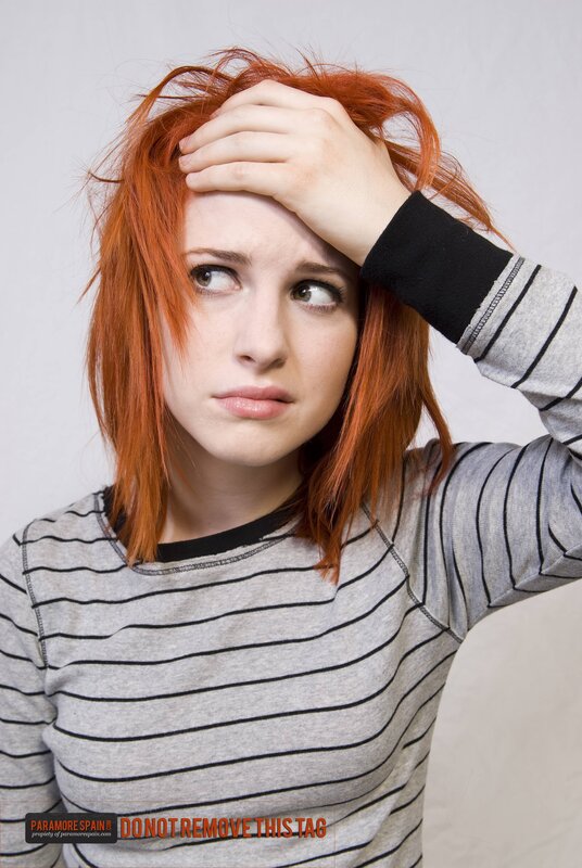 woman with red hair looking confused