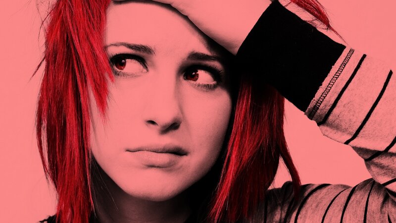 woman with red hair looking distressed