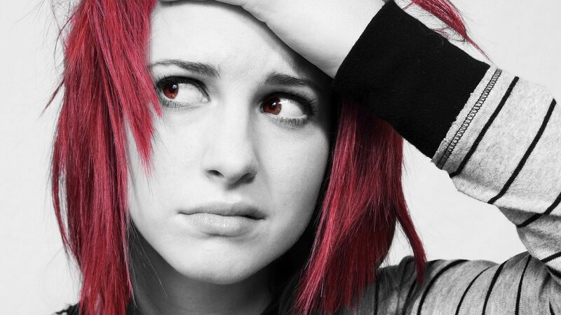 woman with red hair looking distressed