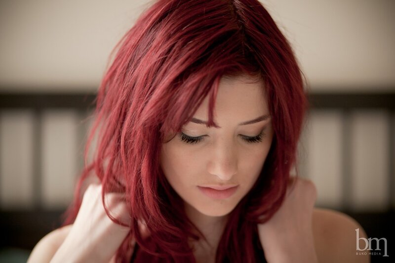 woman with red hair looking down