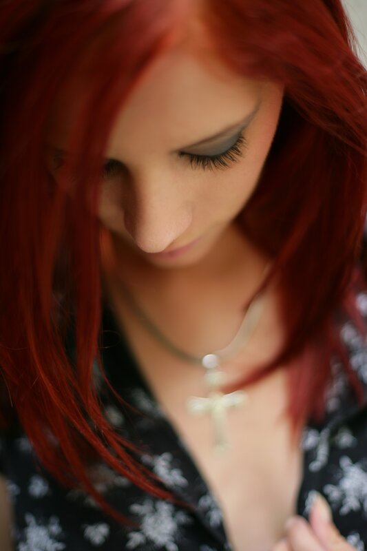 woman with red hair looking down